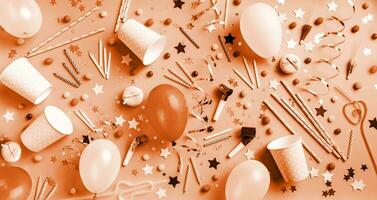 Color of the year 2024, Peach Fuzz. Birthday party with balloons, confetti, candles, candies photo