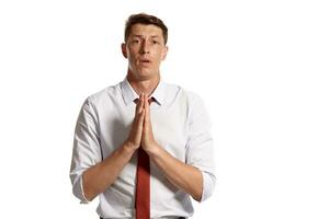 Portrait of a young brunet man posing in a studio isolated over a white background. photo