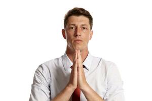 Portrait of a young brunet man posing in a studio isolated over a white background. photo