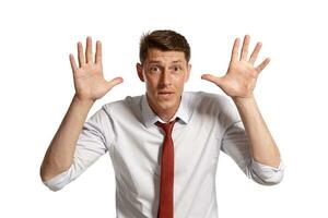 Portrait of a young brunet man posing in a studio isolated over a white background. photo