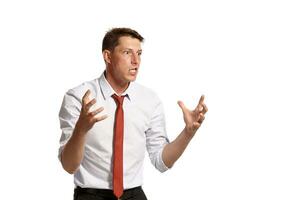 Portrait of a young brunet man posing in a studio isolated over a white background. photo