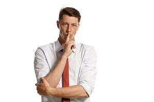 Portrait of a young brunet man posing in a studio isolated over a white background. photo