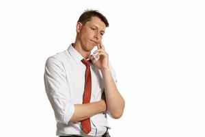Young man in a classic white shirt and red tie posing isolated on white background. photo