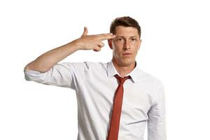 Young man in a classic white shirt and red tie posing isolated on white background. photo