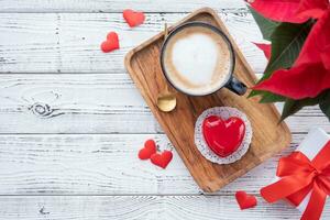 heart shaped glazed valentine cake in bed on wooden tray photo