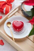 heart shaped glazed valentine cake in bed on wooden tray photo