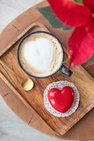 heart shaped glazed valentine cake on wooden tray photo