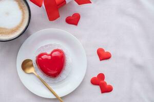 heart shaped glazed valentine cake in bed photo