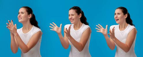 Beautiful woman in a white casual t-shirt posing against a blue studio background. photo