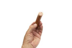 A hand holding a sausage, Bockwurst. Isolated on white background. Bockwurst is a sausage from German cuisine. photo