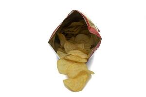 Bag of potato chips, open and front view. With potato chips inside and outside the bag. Isolated on white background. Selective focus. In Western countries, they are a very important part of the snack photo