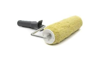 Paint roller to paint rough facades and concrete or cement walls. Isolated on white background. photo