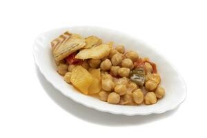Chickpea stew with cod. Food widely consumed at Easter, in Spain, chickpeas with cod. Isolated on white background. Spanish traditional foods. photo