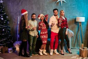 Young people with glasses of champagne at Christmas party photo