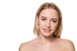 Beautiful face of young blond woman with clean fresh skin and natural make up on white background. photo