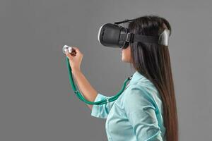 Young attractive doctor in a virtual reality glasses photo