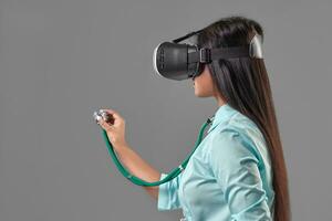 Young attractive doctor in a virtual reality glasses photo