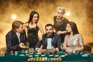 Poker players sitting around a table at a casino. photo