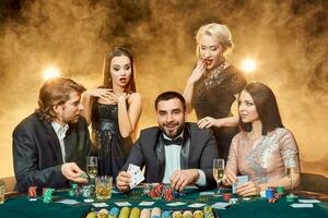 Poker players sitting around a table at a casino. photo
