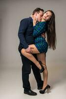 Couple posing in studio. On gray background photo