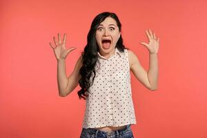 Studio shot of a beautiful girl teenager posing over a pink background. photo