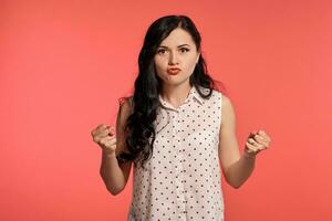 Studio shot of a beautiful girl teenager posing over a pink background. photo