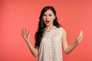 Studio shot of a beautiful girl teenager posing over a pink background. photo