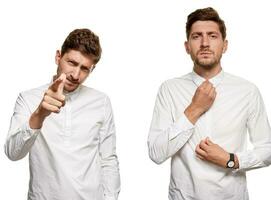 Handsome man in a white shirt makes faces, isolated on a white background photo