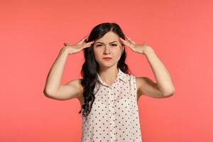 Studio shot of a beautiful girl teenager posing over a pink background. photo