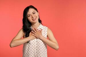 Studio shot of a beautiful girl teenager posing over a pink background. photo