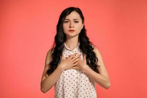 Studio shot of a beautiful girl teenager posing over a pink background. photo