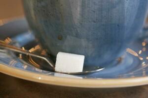 sugar cube and coffee cup on a table photo