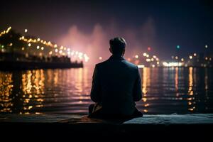 AI generated Reflective night suited man sits at dock edge in contemplation photo