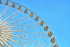 Ferris wheel against or contrast the background of the blue sky photo