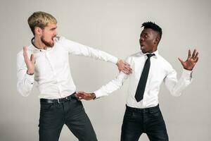 Two stylish men posing and having fun on white background. photo