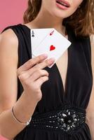 Beautiful caucasian woman with poker cards gambling in casino. Studio shot photo