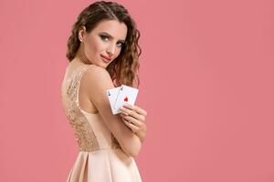 Beautiful caucasian woman with poker cards gambling in casino. Studio shot photo