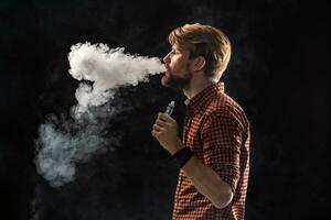 A young man with a beard and a stylish hairstyle in a shirt, smoking a cigarette, a viper, a room, a studio, smoke, enjoyment photo