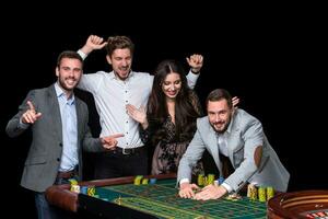 Upper class friends gambling in a casino. photo