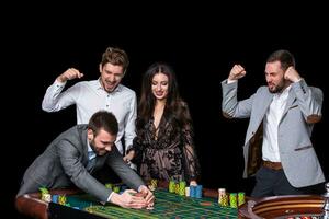 Upper class friends gambling in a casino. photo