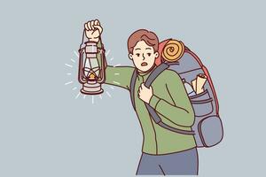 Man is engaged in hiking and carries large backpack on back, holding kerosene lantern to light way in dark. Frightened guy hears rustle in bushes and looks around while hiking in forest vector