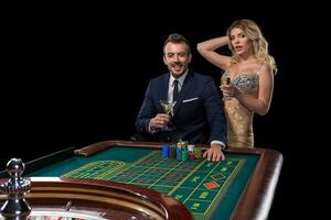 Couple gambling at roulette table in casino photo