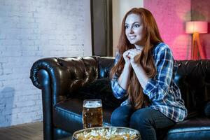 Emotional woman football fan at home sofa couch watching excited photo