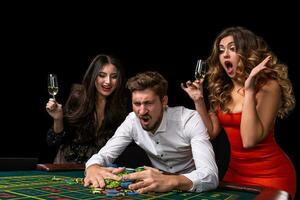 Adult group celebrating friend winning at roulette photo