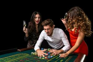 Adult group celebrating friend winning at roulette photo