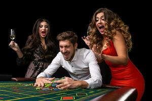 Adult group celebrating friend winning at roulette photo