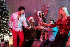 Young people with glasses of champagne at Christmas party photo