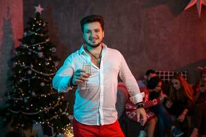 Christmas, x-mas, New year, winter, happiness concept - smiling man with a glass of champagne photo