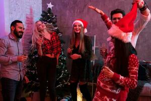 Young people with glasses of champagne at Christmas party photo