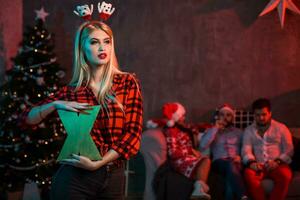 Christmas, x-mas, New year, winter, happiness concept - smiling woman in santa helper hat with a wooden letter X. photo